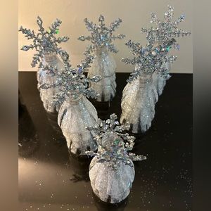 Holiday frosted display trees with silver snowflake tops